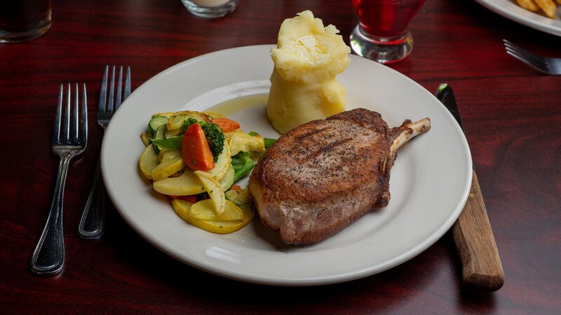 Steak entree with side of mashed potatoes and vegetables